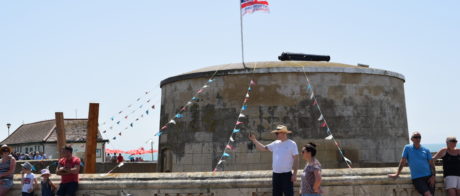 External view of Martello tower, with people standing around outside.
