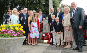 A photograph of Major Bromley's family stood at the memorial stone