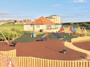 A photograph of the Salts recreation ground play area with cafe in background