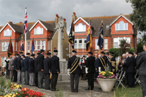 A photograph of people marking a silence around the war memorial