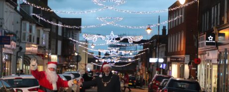 The Mayor and Sants standing in Seaford town centre pushing a button for the Christmas lights to come on