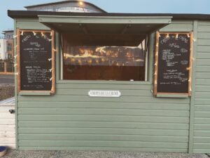 wooden green beach shack selling pancakes