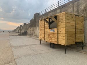 wooden cabin on seafront with hatch 