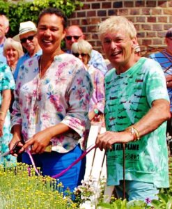 From 2018, TV Presenter Juliet Sargeant (left) cutting the ribbon for the Mayor of Seaford’s Garden Trail organised by Coronation Champion Geoff Stonebanks (right). 