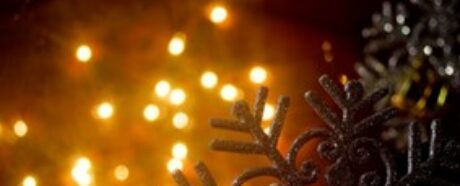 Snowflake tree decoration with glowing lights in the background