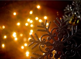 Snowflake tree decoration with glowing lights in the background