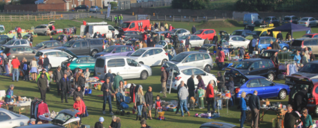 People attending a car boot sale in a field in Seaford.