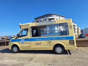 Carnival Ice cream van parked along Seaford promenade. 