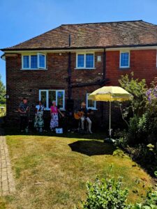 Local group singing in the garden outside the Mayor of Seaford's home.
