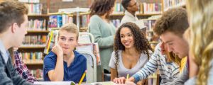 Group of students sitting together studying.
