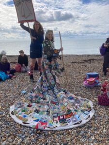 The Mayor of Seaford wearing the coat of Hopes at Seaford beach.