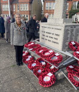The Mayor of Seaford standing next to the War Memorial in Seaford at the Remembrance Service.