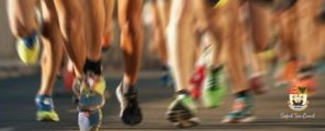 Blurred photo or runners legs and trainers.