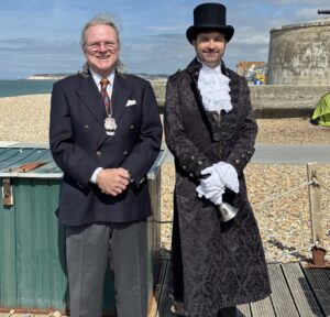 The Deputy Mayor, Cllr Rod Bucanan and the Deputy Town Crier at Sussex Day ceremony at Seaford Beach.