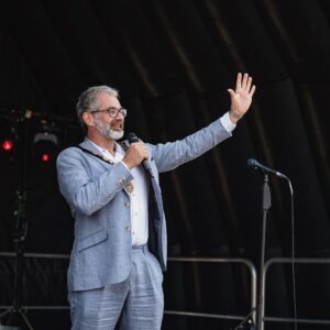 The Mayor of Seaford on a stage with a microphone in his hand.